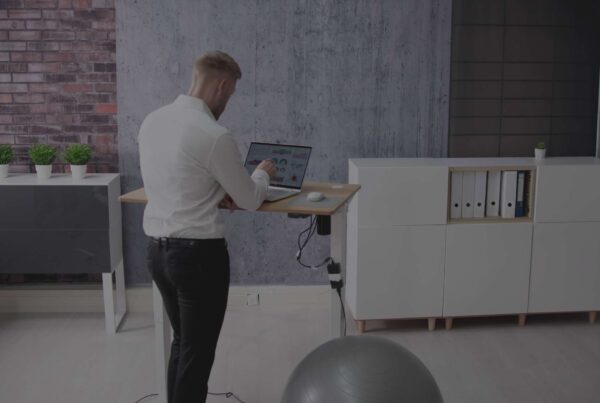 back-view-adult-male-working-from-home-with-sit-stand-desk